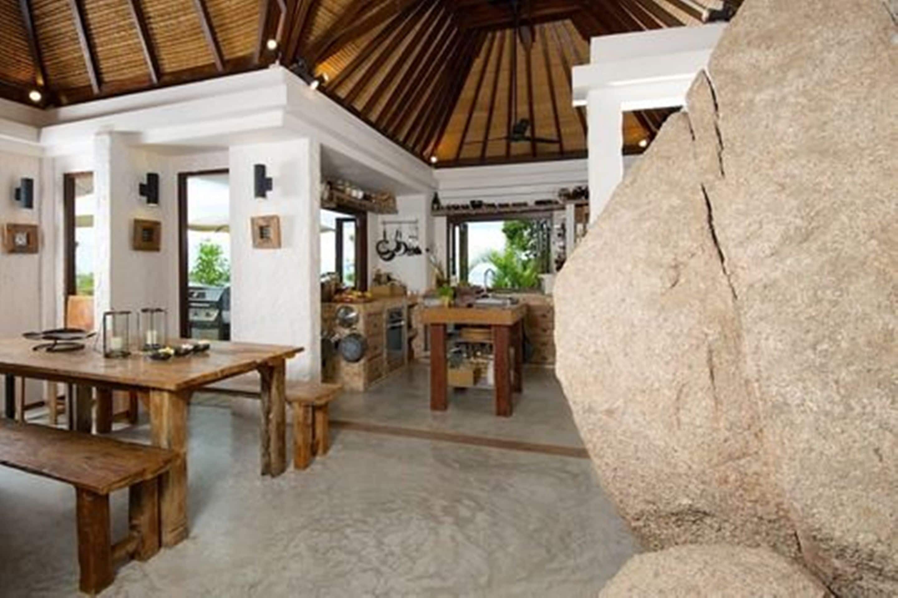 A spacious room with a high ceiling and a large rock centerpiece.