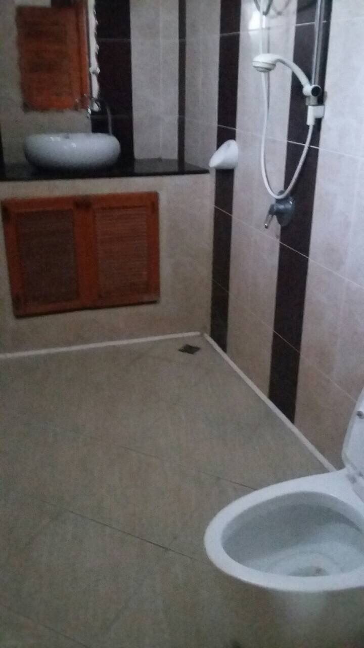 A bathroom with a toilet, a sink, and a shower.