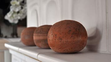 Three spherical objects on a white mantelpiece.