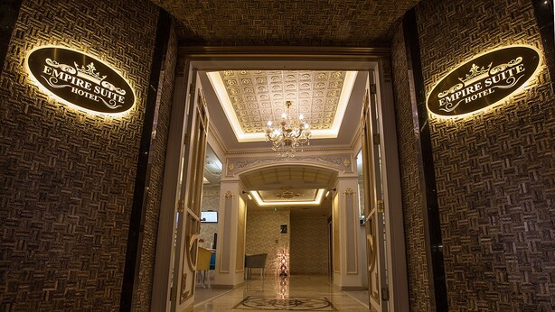 A grand entrance to the Empire Suite Hotel with a detailed ceiling and a chandelier. - Empire Suite Hotel (Istanbul)