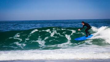 A person surfing on a wave in the ocean.