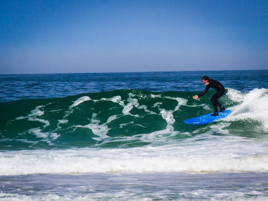 A person surfing on a wave in the ocean.