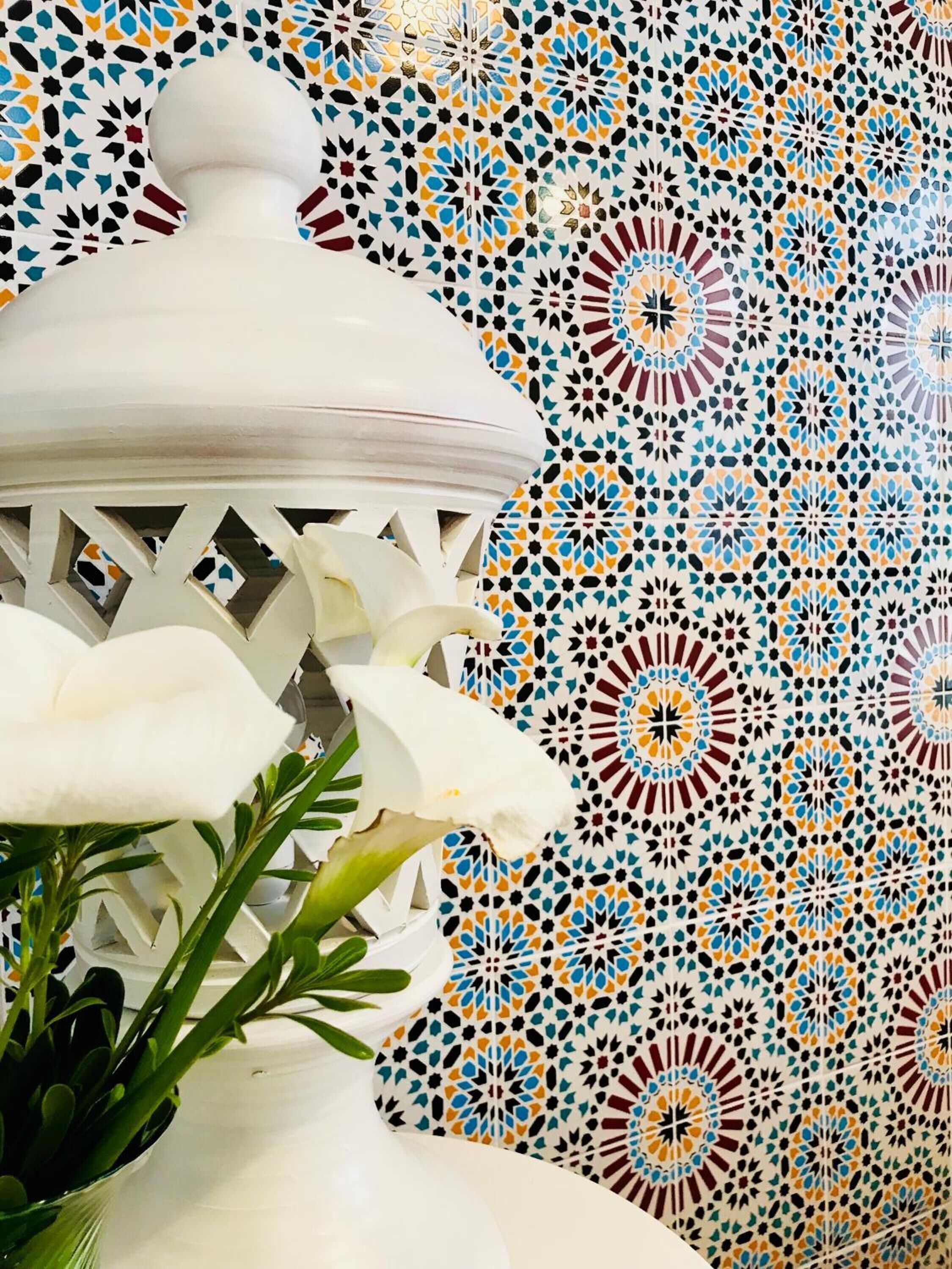 A white lantern with a geometric patterned background.