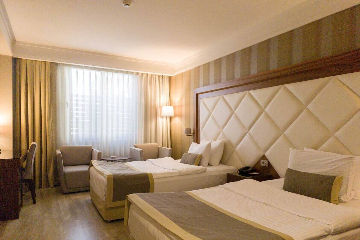 Standard Triple Room | Minibar, in-room safe, desk, soundproofing