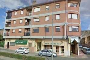 A multi-story building with a hostel and a restaurant on the ground floor.