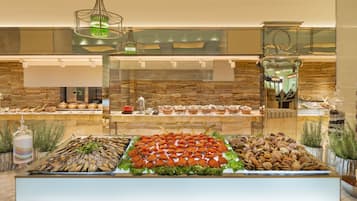A buffet with seafood, salads, and nuts.