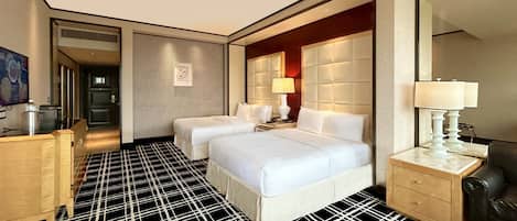 A hotel room with two beds, a large mirror, a wooden nightstand, and a checkered floor.