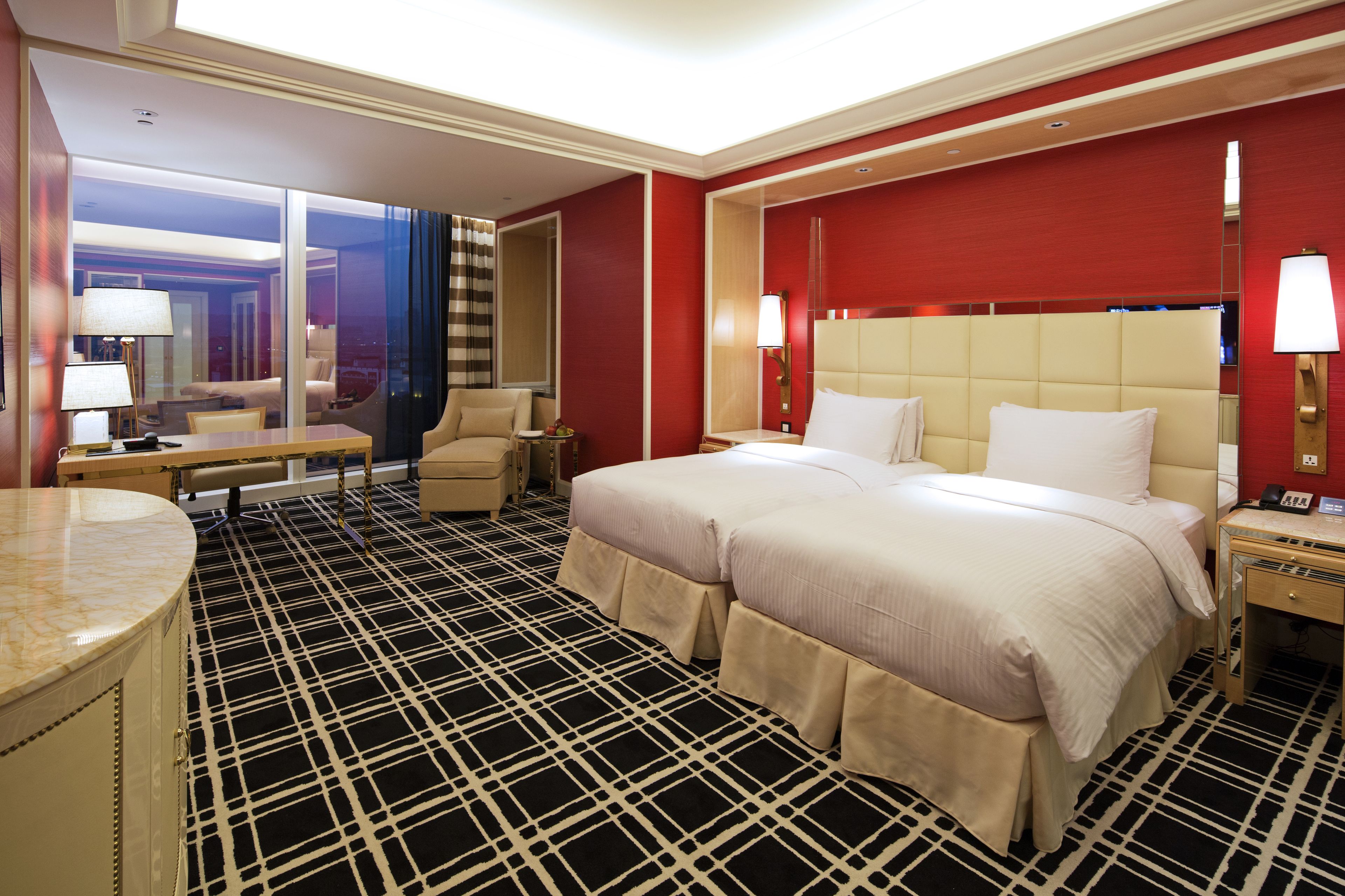 Una habitación de hotel con una cama grande, un escritorio y una silla.