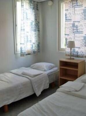 Desk, iron/ironing board, bed sheets