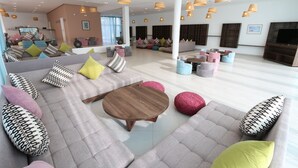 A spacious living area with a large sofa set, a wooden coffee table, and colorful cushions. - Lunja Village Taghazout (Tamri)