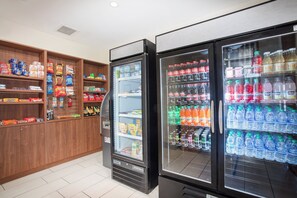 A vending area with snack options and a beverage dispenser. - Holiday Inn Express & Suites Manhattan by IHG (Manhattan)