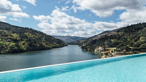 A swimming pool with a view of a lake and hills. - Douro Royal Valley Hotel & SPA (Baiao)