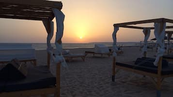 On the beach, white sand, free beach cabanas, beach towels