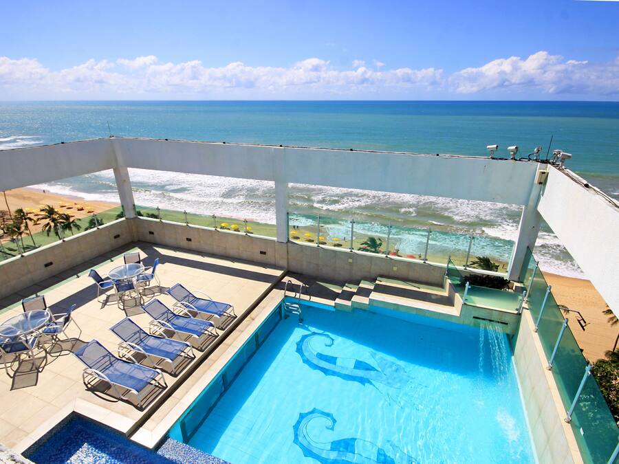 Una piscina en la azotea con vista a la playa y al océano.