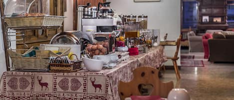 A buffet setup with various food items and serving utensils.