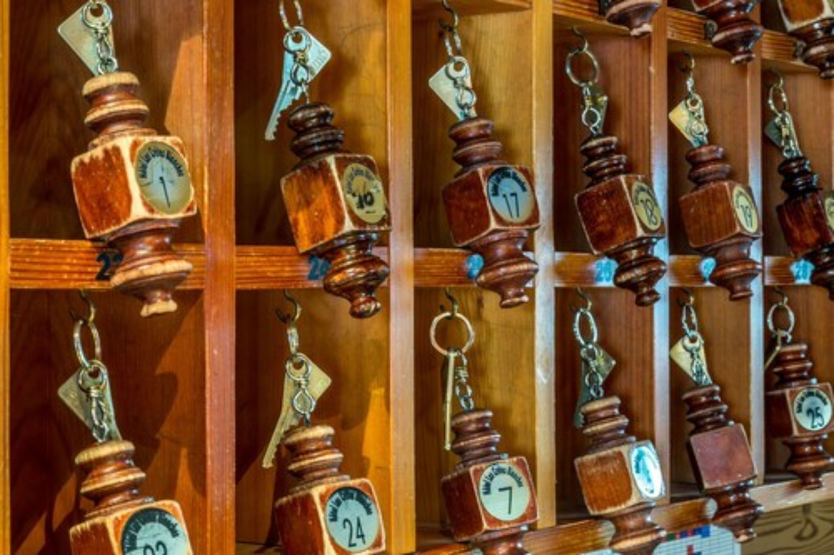 A wooden display with numbered wooden weights hanging from hooks.