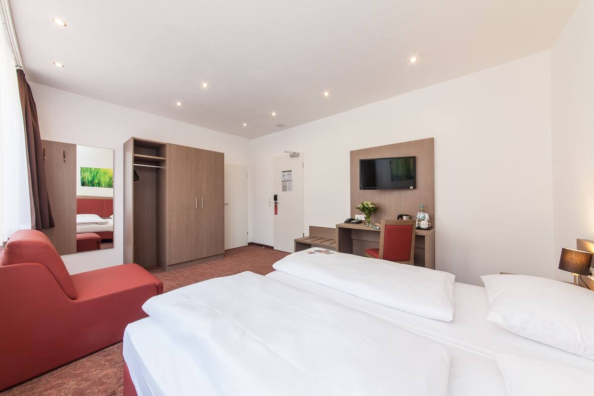 Ropa de cama hipoalergénica y caja de seguridad en la habitación 