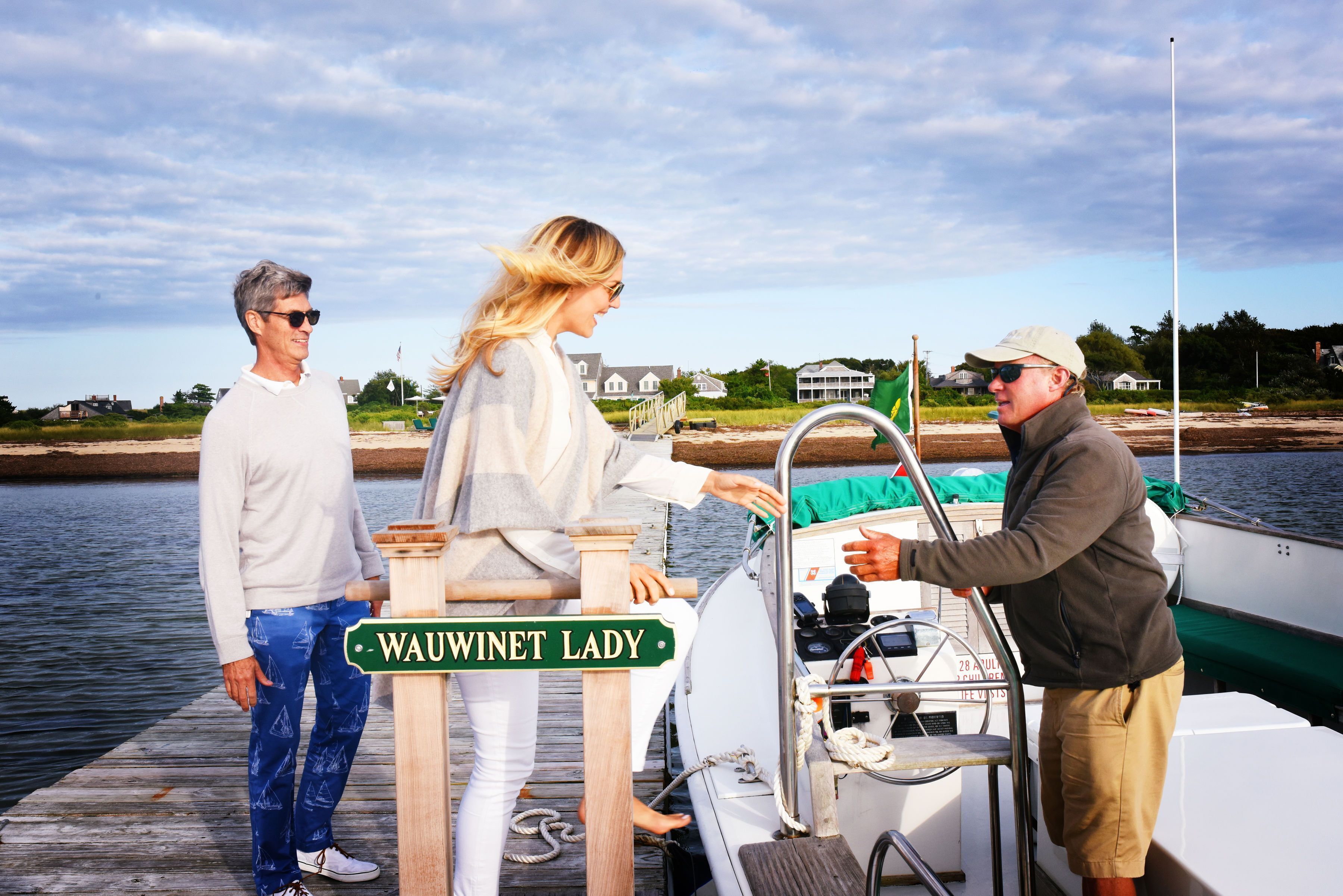 A wooden dock with a sign reading "Wauwinet Lady."