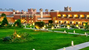 A hotel with a courtyard, multiple buildings, and well-lit pathways. - Helnan Auberge Hotel (Sinnuris)