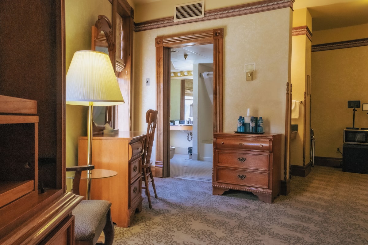 deluxe room, 2 queen beds, refrigerator | living area | flat-screen tv