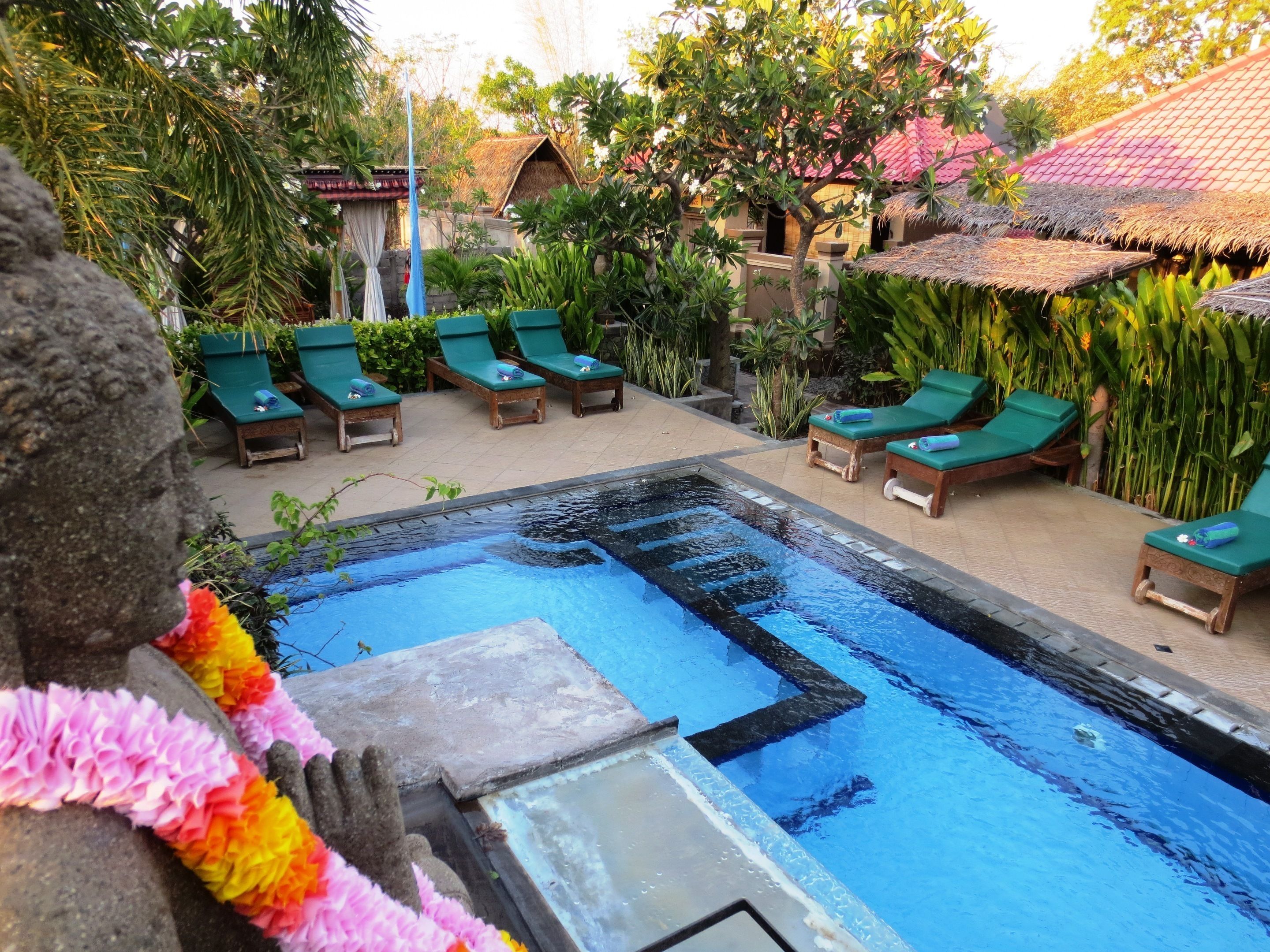 outdoor pool, open 7:00 am to 7:00 pm, pool umbrellas, pool loungers