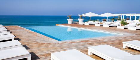 Seasonal outdoor pool, open 10:00 AM to 8:00 PM, pool umbrellas