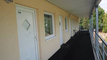 A corridor with doors numbered 14, 15, and 16, leading to rooms.