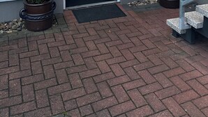 A building entrance with a glass door, a metal staircase, and two potted plants. - Messe Motel Laatzen (Laatzen)