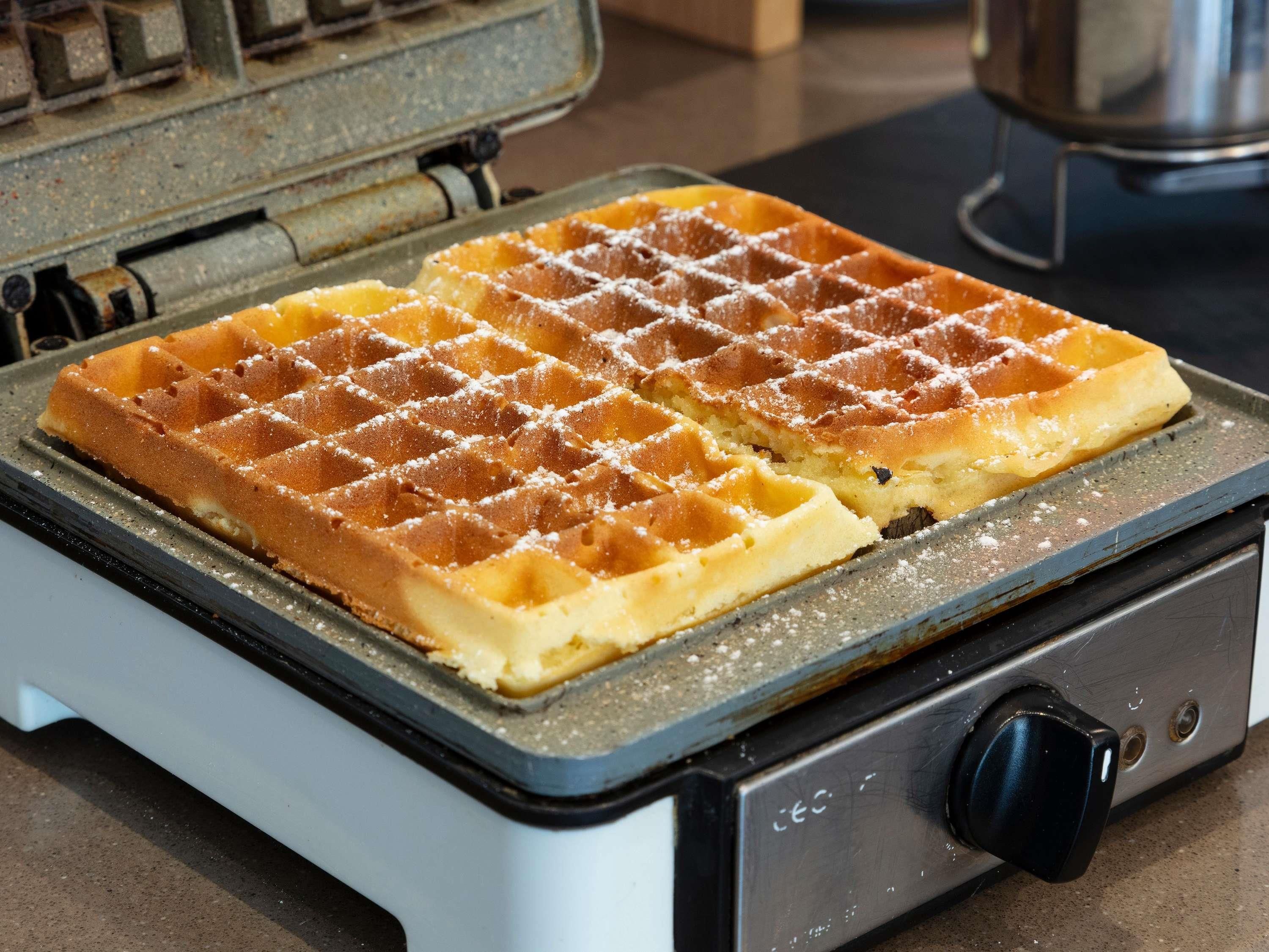 A waffle iron with waffles on it.