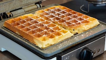 A waffle iron with waffles on it.