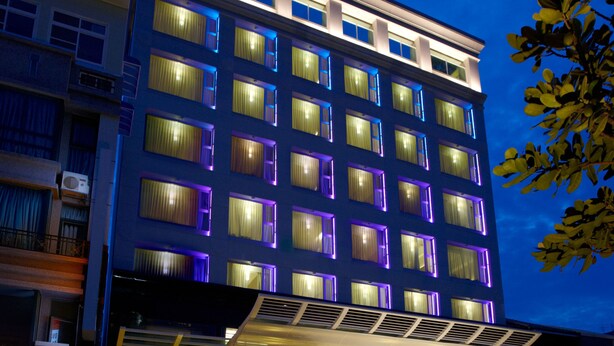 A multi-story hotel with a modern facade, large windows, and a well-lit entrance. - Yuh Tong Hotel (Chiayi City)