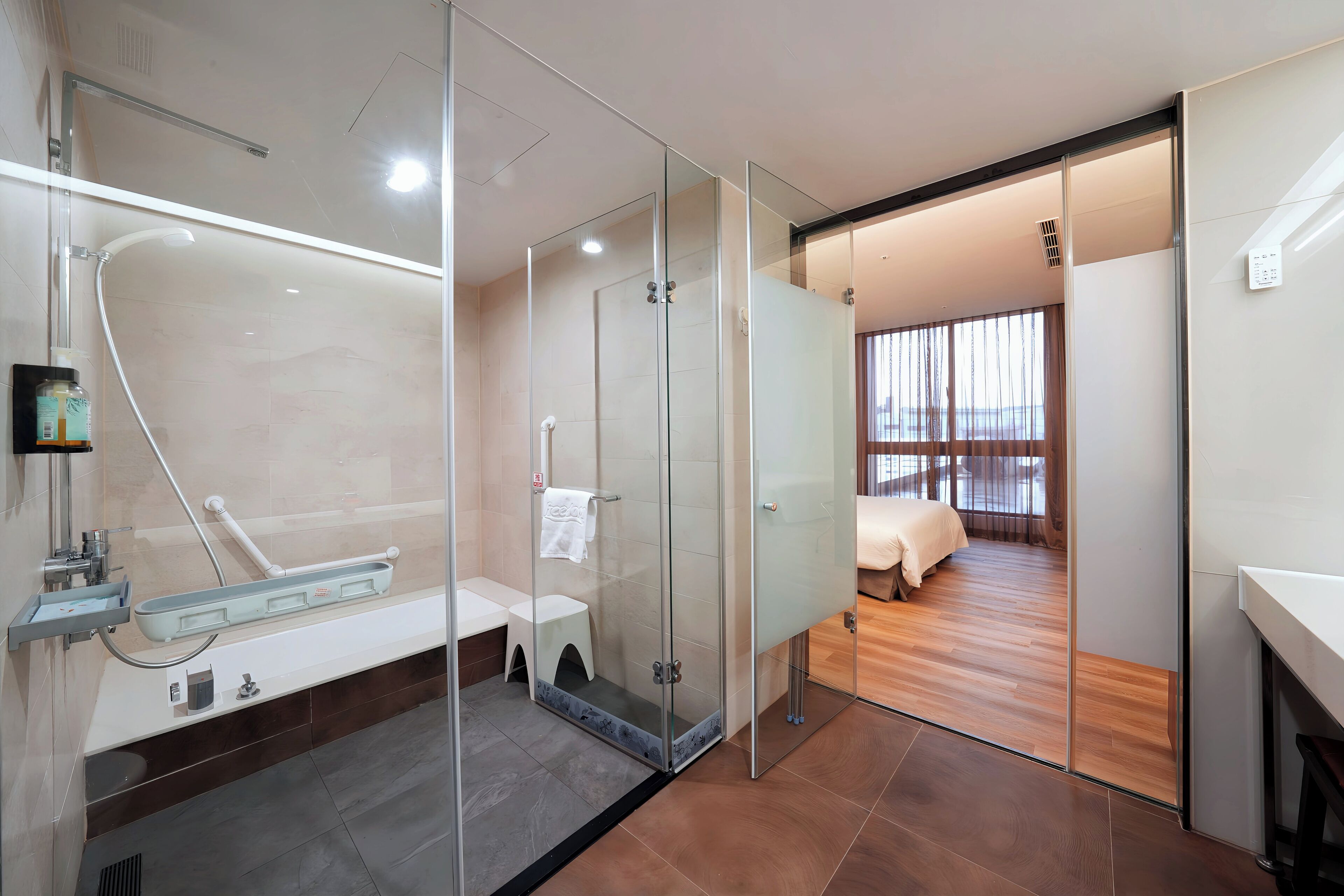 deluxe quadruple room, multiple beds | bathroom | free toiletries, hair dryer, slippers, towels