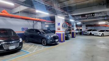 A multi-level parking garage with cars parked in designated spaces, including a handicapped parking spot.