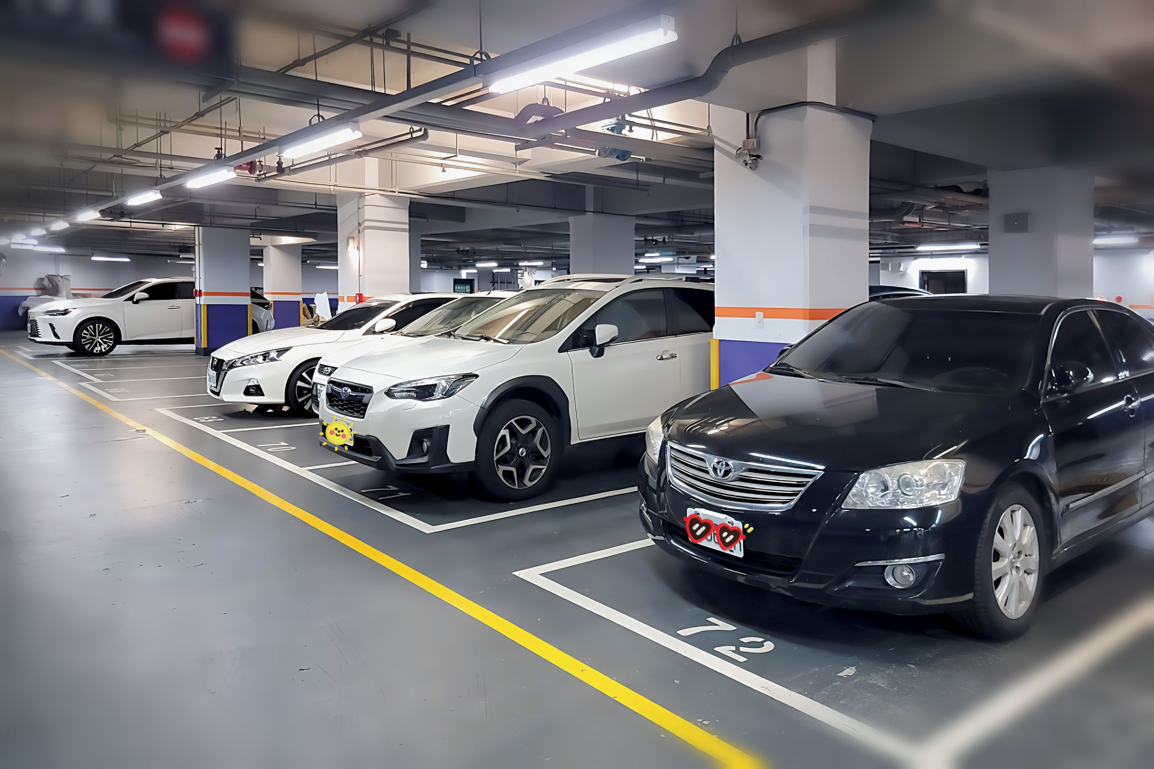 A multi-level parking garage with cars parked in designated spaces.