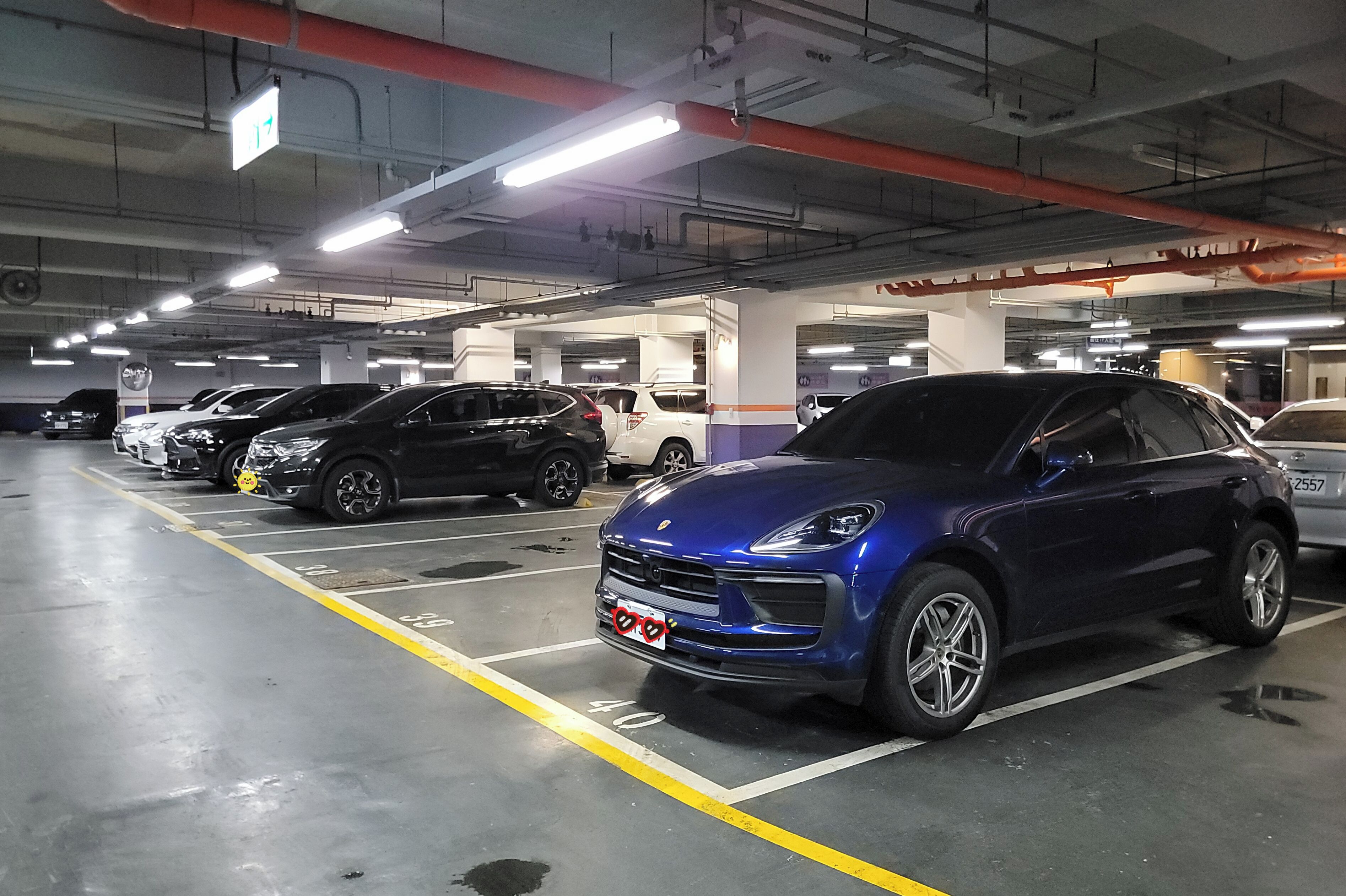 A multi-level parking garage with several cars parked in designated spaces.