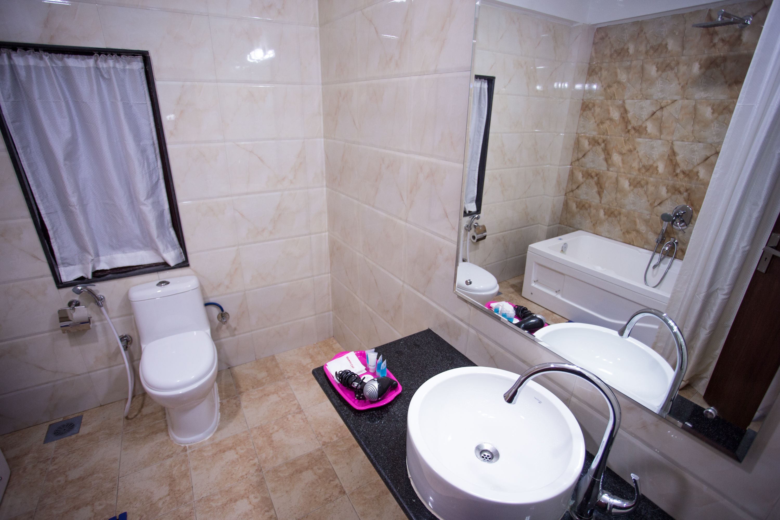 A bathroom with a toilet, sink, and bathtub.