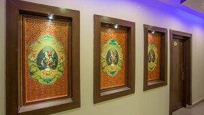 A hallway with three framed artworks on the wall. - Aryatara Kathmandu Hotel (Kathmandu)