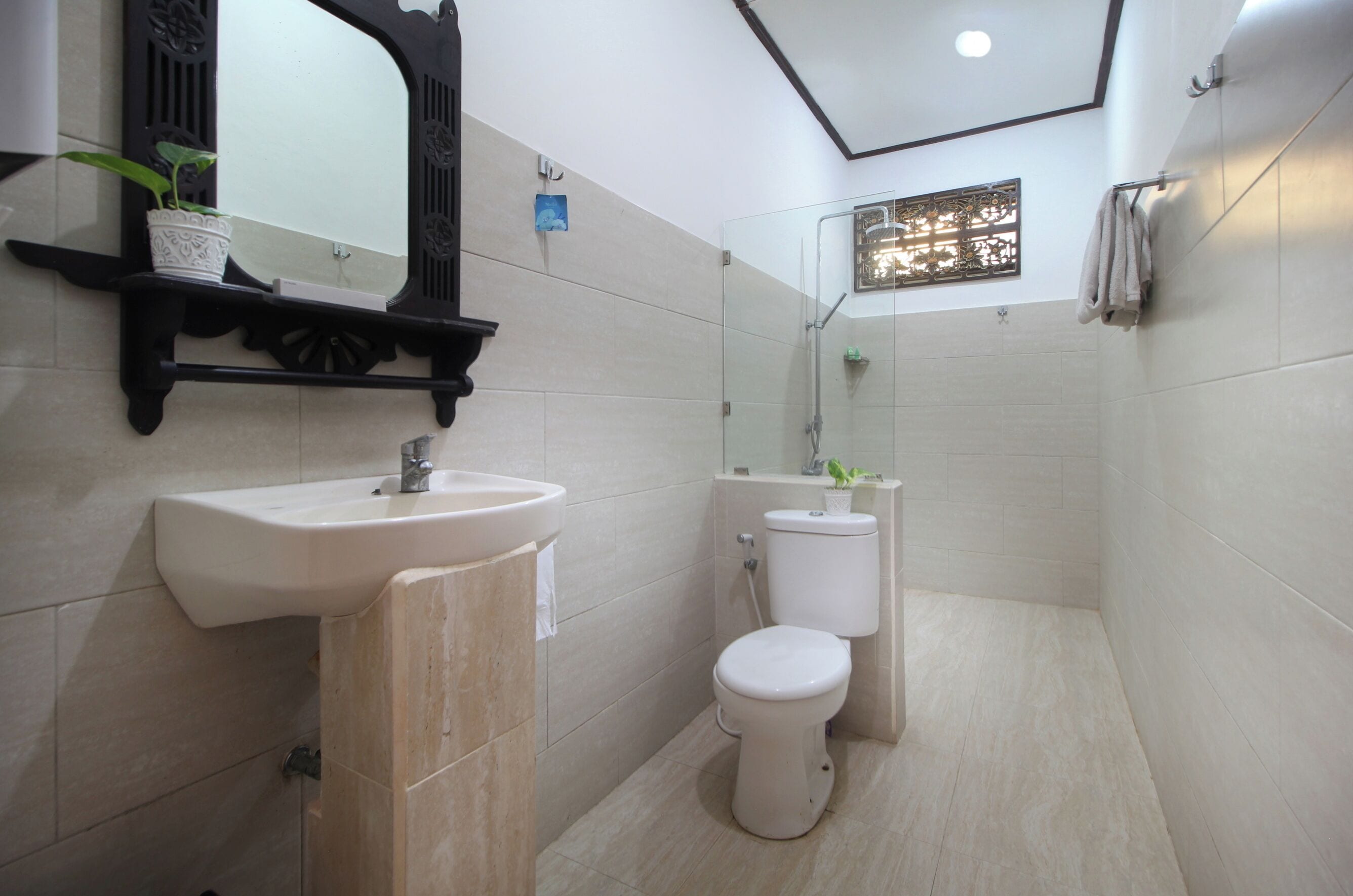 A modern bathroom with a sink, toilet, and shower.