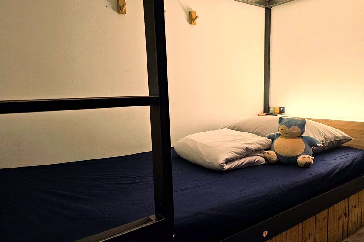 A bunk bed with a blue mattress and a wooden headboard, labeled A602.