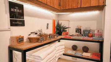 A wooden counter with baskets, price tags, and a mirror.