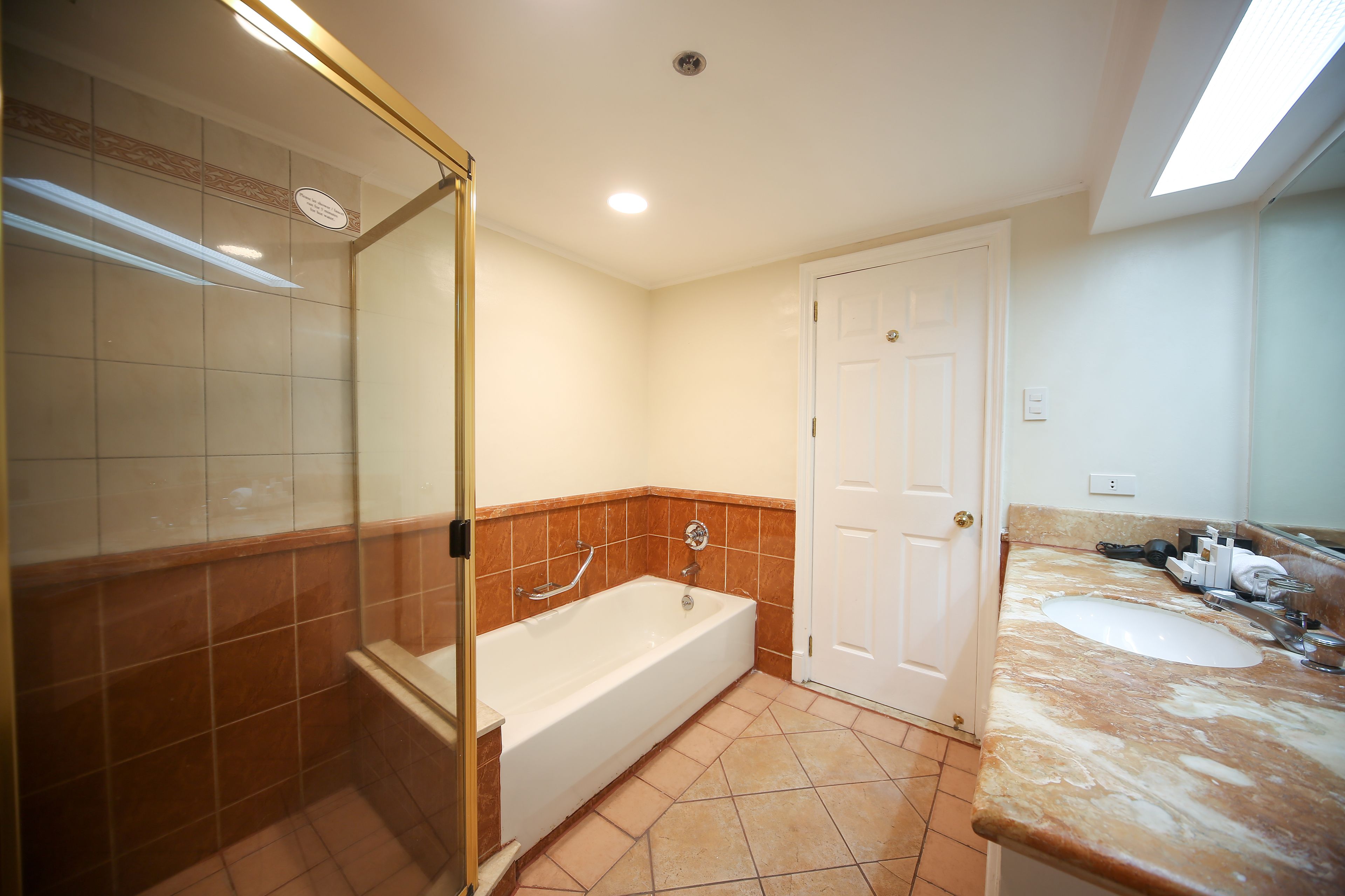 one bedroom suite | bathroom | separate bathtub and shower, hydromassage showerhead, free toiletries