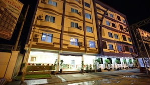 A multi-story hotel with balconies, a ground-level entrance, and a visible signboard. - The Hotel 78 (Mandalay)