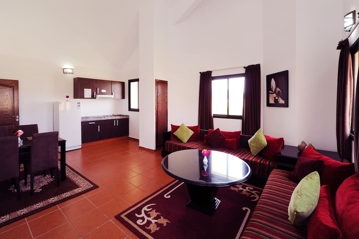 A compact living space with a dining area, kitchen, and seating area.