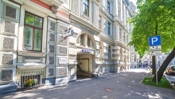 A historic building with ornate architectural details, including decorative window frames and a prominent entrance. - Mosaic Hotel (Riga)