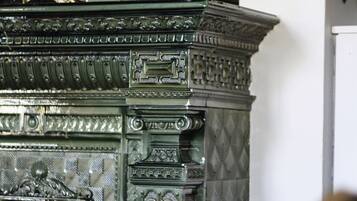 A detailed, ornate metal structure with intricate carvings and a decorative figure on top.