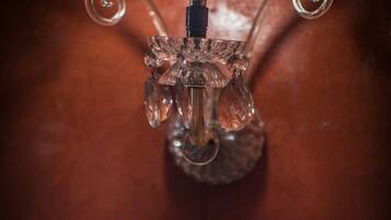 A wall-mounted light fixture with a clear glass shade and a visible bulb.