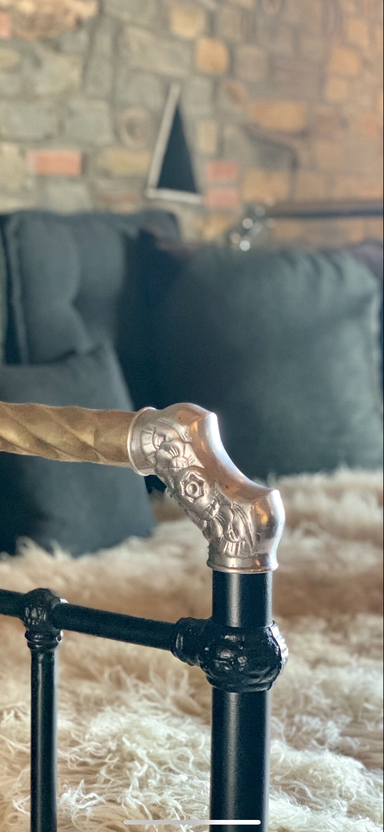 A close-up of a metal object with intricate designs, possibly a part of furniture or decor.