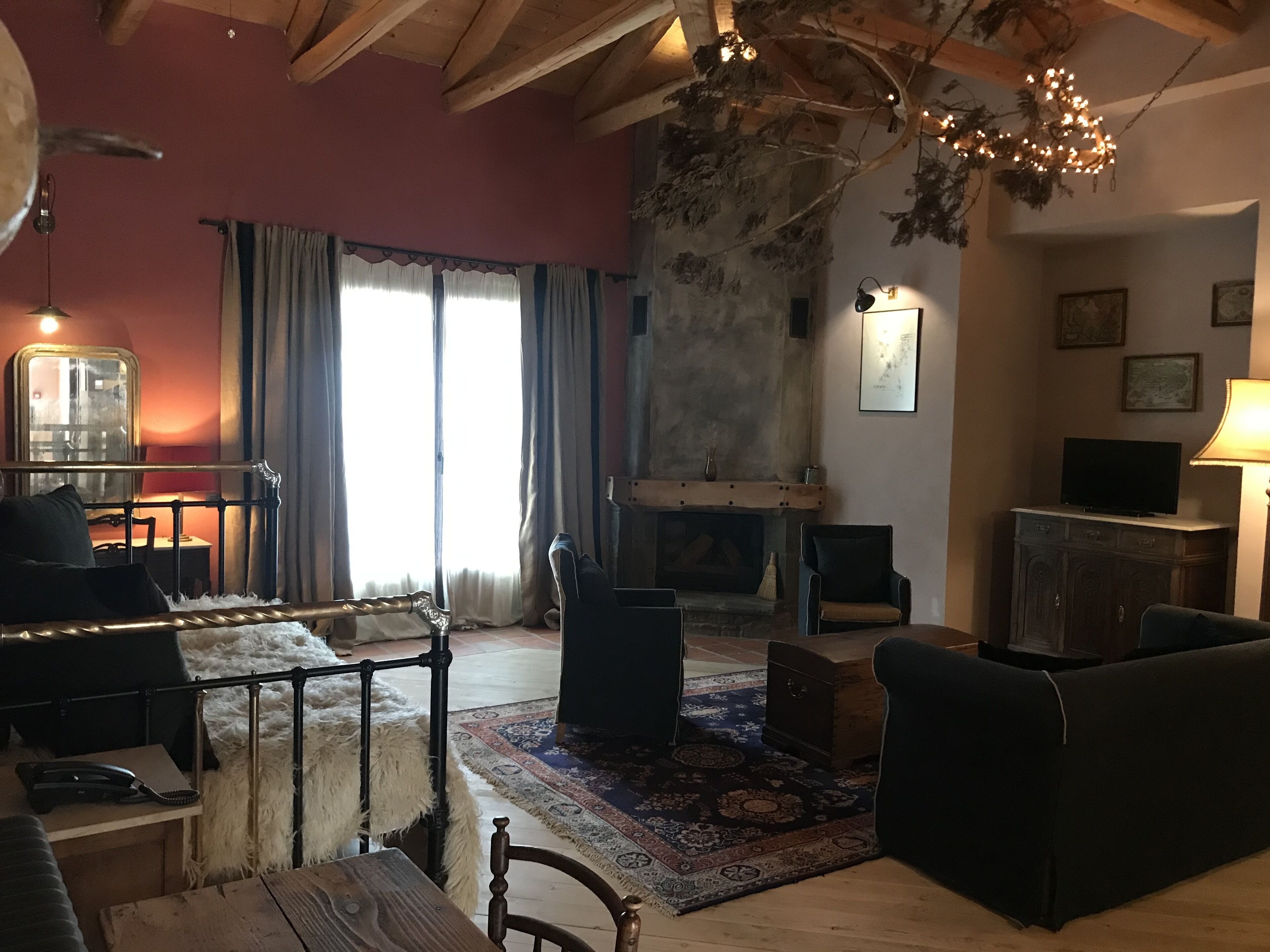 A cozy living room with a fireplace, a sofa, a coffee table, and a television.