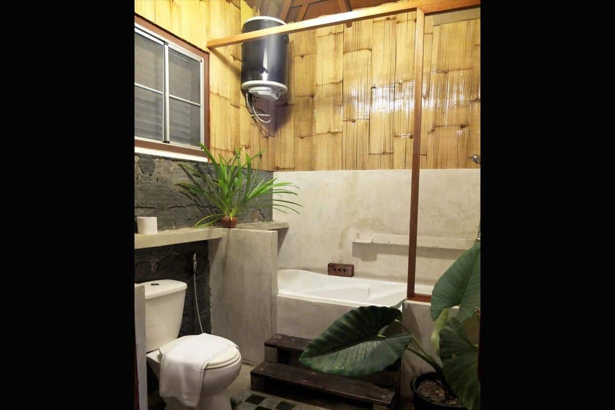 A compact bathroom with a toilet, sink, and bathtub.