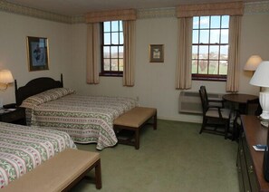 A room with two beds, a desk, a chair, and two windows with curtains. - Guest Quarters at The Bridges Golf Club (Abbottstown)